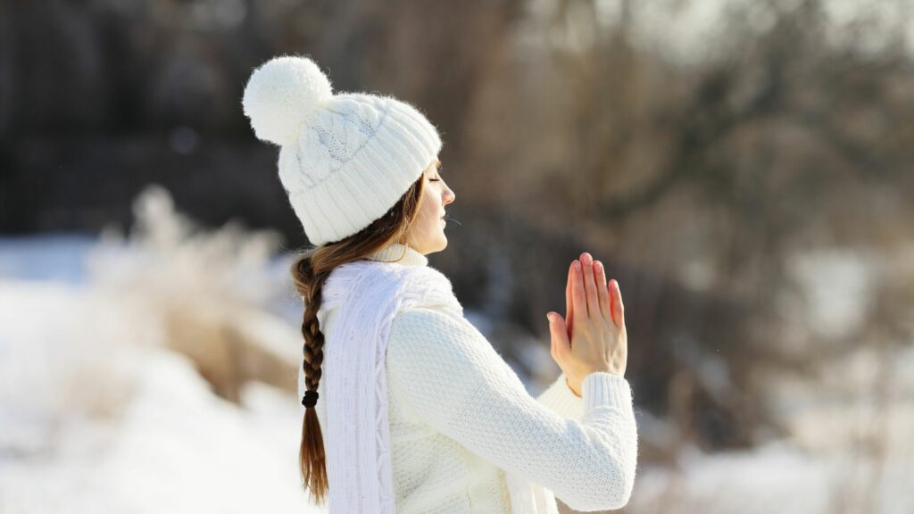 Anjali Mudra practiced outside to soak up the sun and fresh air that can help fend off winter blues.