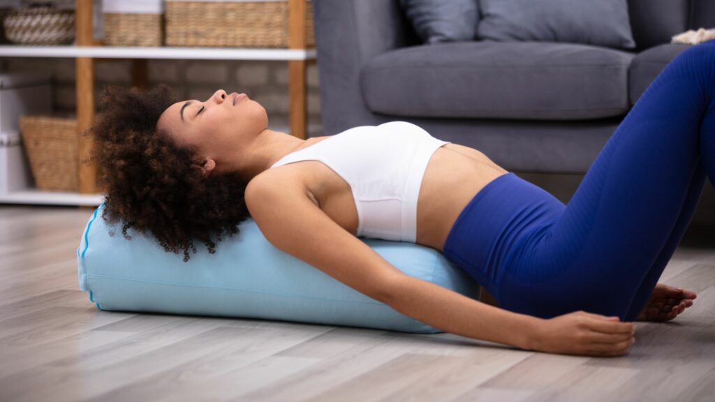 Woman practicing a Restorative Backbend for spinal health and relaxation