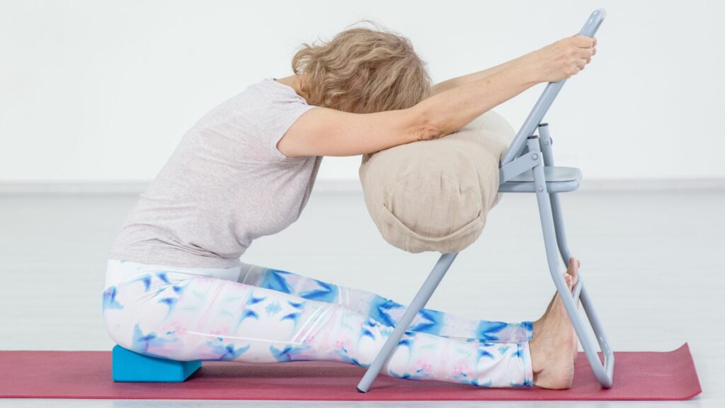 Restorative Forward Bend Yoga Pose using a chair to help calm anxiety 