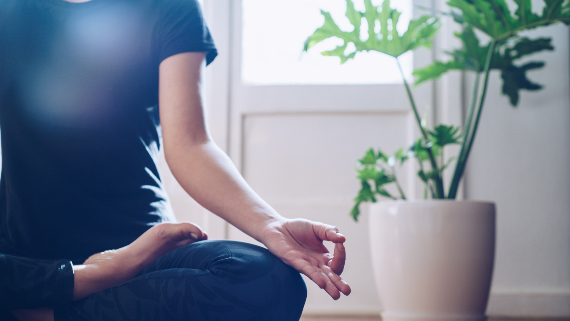 Woman doing yoga in the morning at her home.