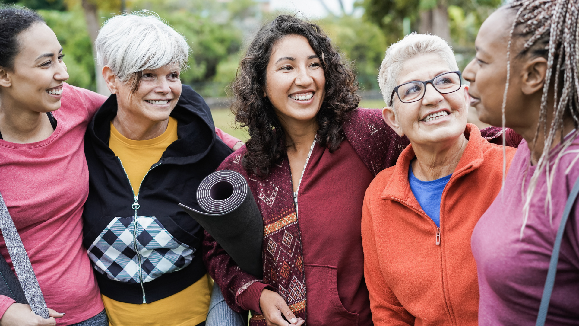 Happy multi generational women having fun together after yoga workout outdoors in a class geared toward stress-related inflammation