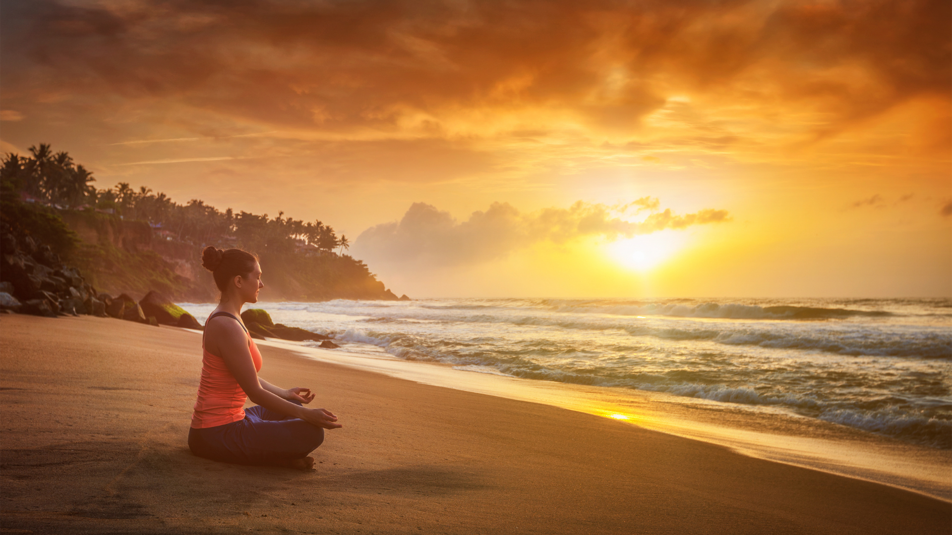 Young Yogi practicing meditation and relaxing in Lotus Pose in a practice that draws on Internal Family Systems Therapy