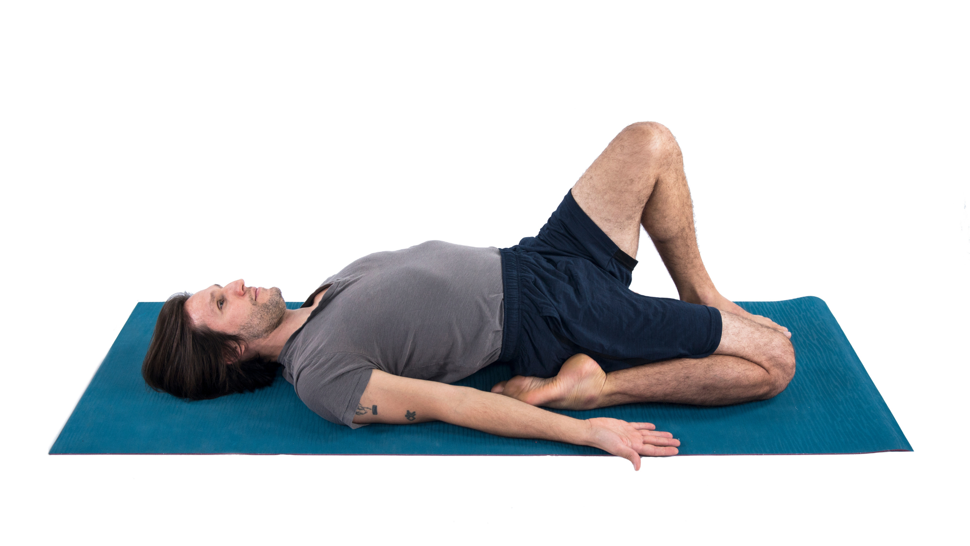 Young attractive woman practicing yoga, lying in Reclining Hero exercise,  Supta Virasana pose, working out wearing sportswear, blue suit, indoor full  length, white studio background Stock Photo | Adobe Stock