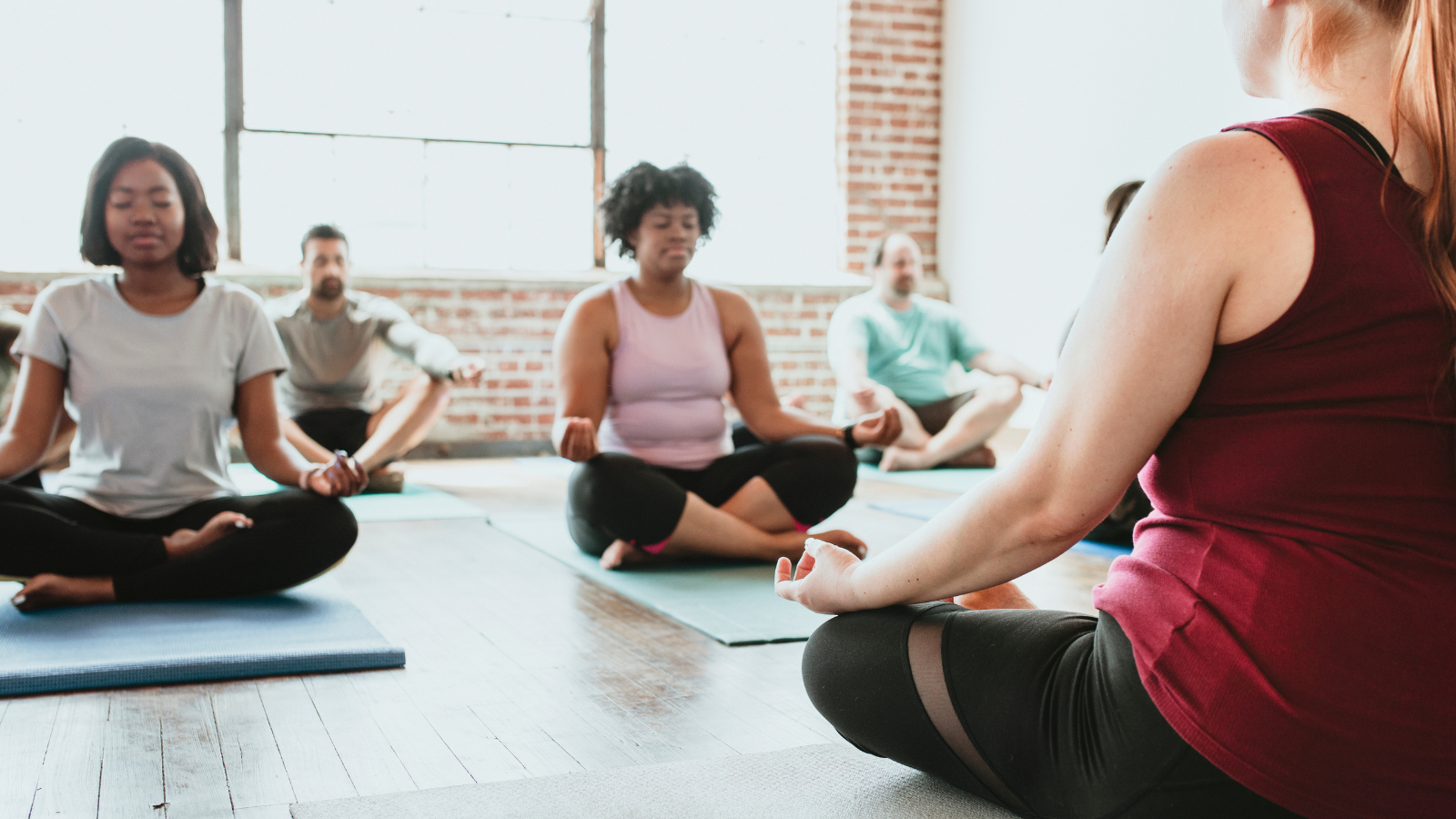 Yoga class meditation with Yoga Teacher leading the class one of many ways a yoga teacher can create a yoga teaching niche.