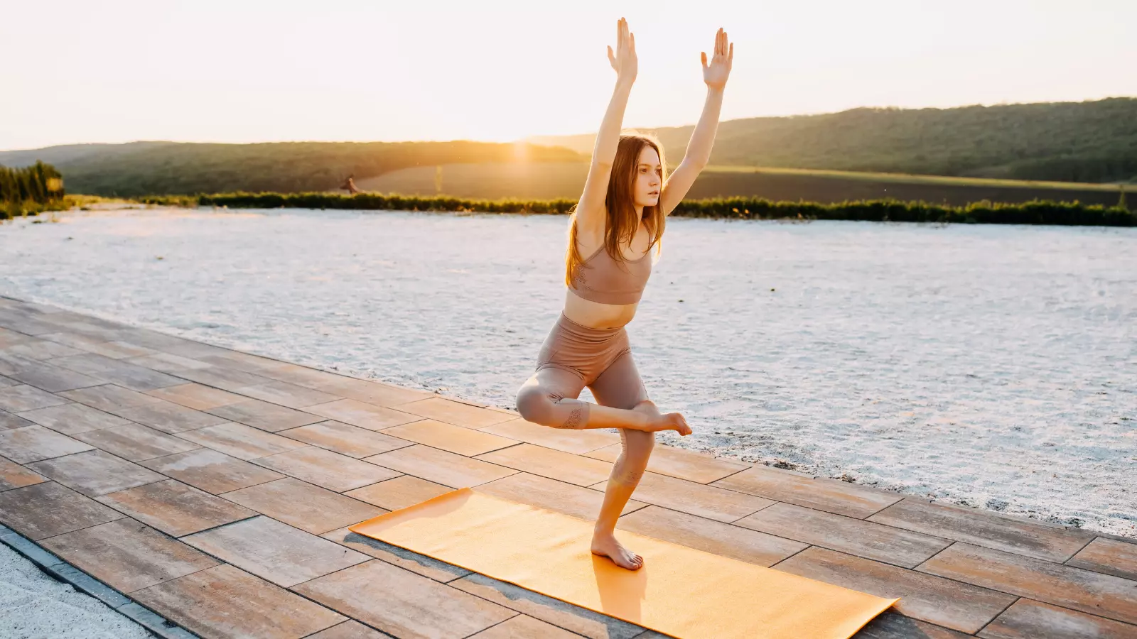 Chair Pose or Utkatasana can also be practiced with one leg lifted up or crossed over the opposite thigh as a Chair Pose variation.