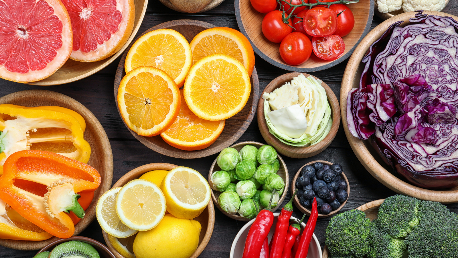 Different products rich in vitamin C on wooden table