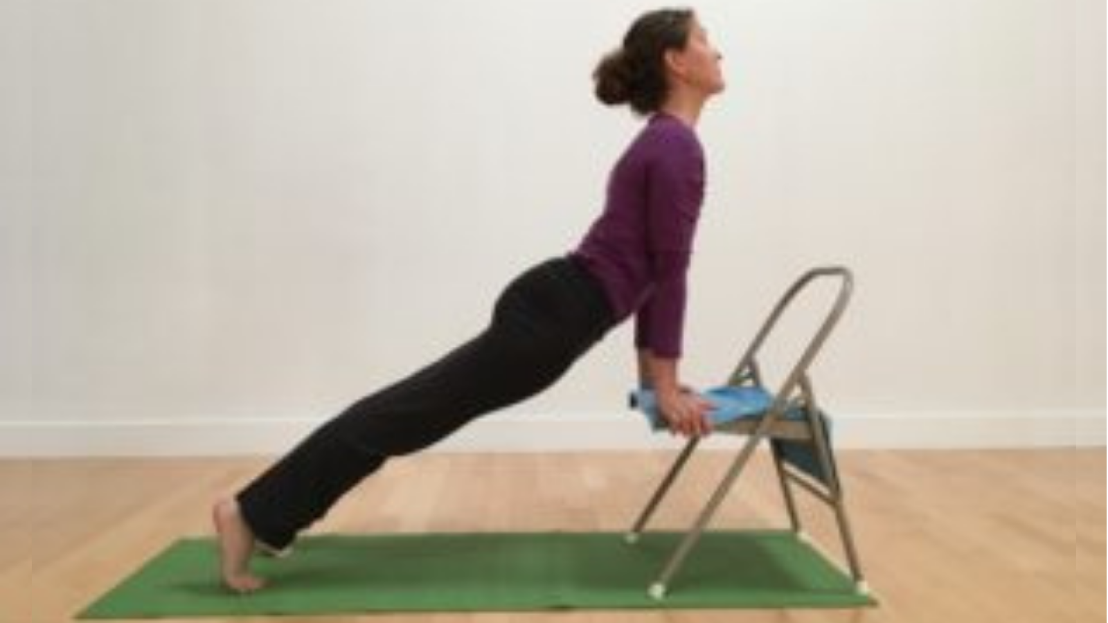 An UpWard-Facing Dog Pose variation with a chair.