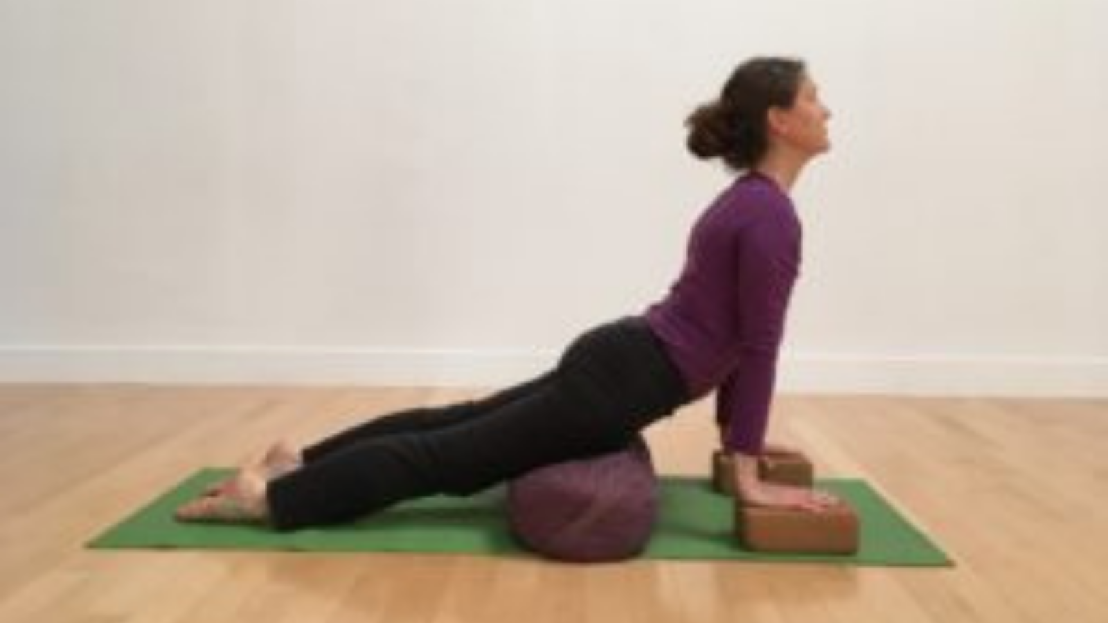 Using a bolster and yoga blocks to support the Upward-Facing Dog Pose shape.