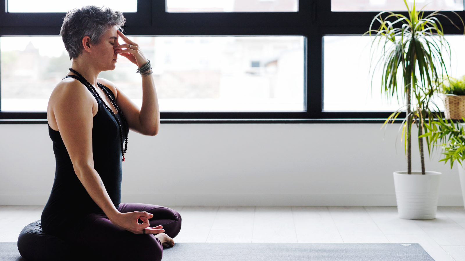 Woman practicing yoga Alternate Nostril Breathing or nadi shodhana