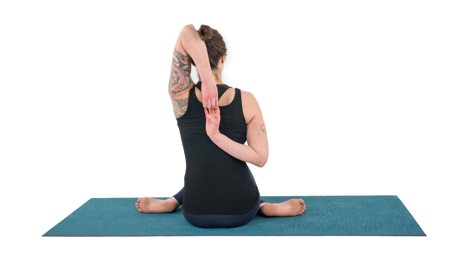 Woman practicing gomukhasana, a yoga for tight shoulders that stretches and strengthens the shoulders to help relieve tension