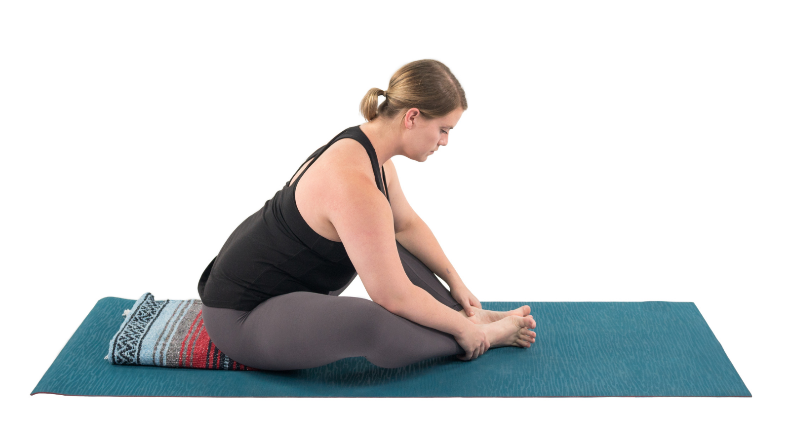 Baddha Konasana or Butterfly Pose with blanket props to assist with the pelvis tilting forward