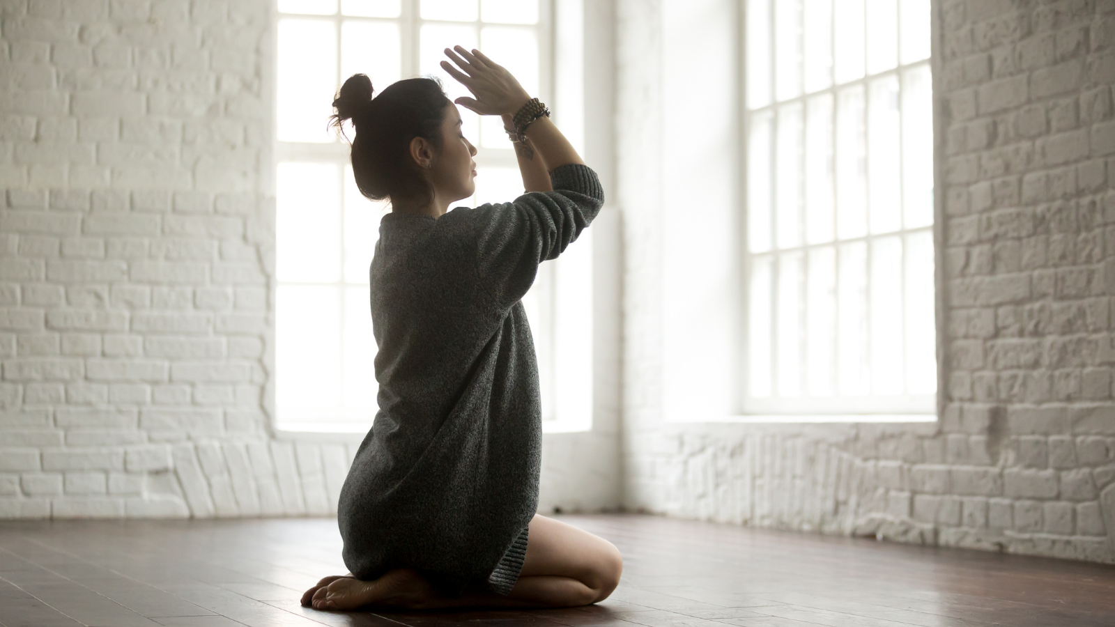 Young attractive yogi woman practicing yoga's vajrasana Pose.