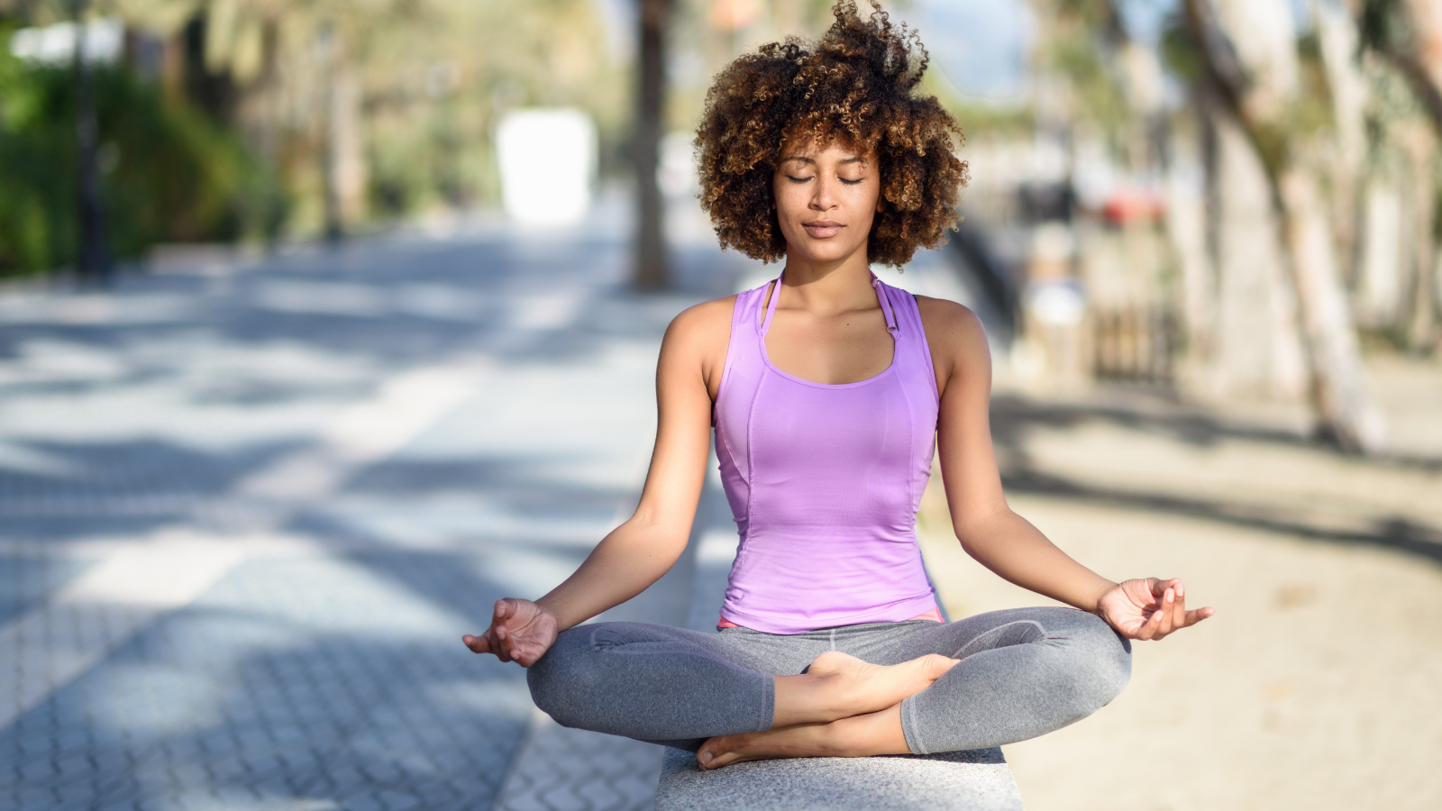 Woman meditating at the beach.