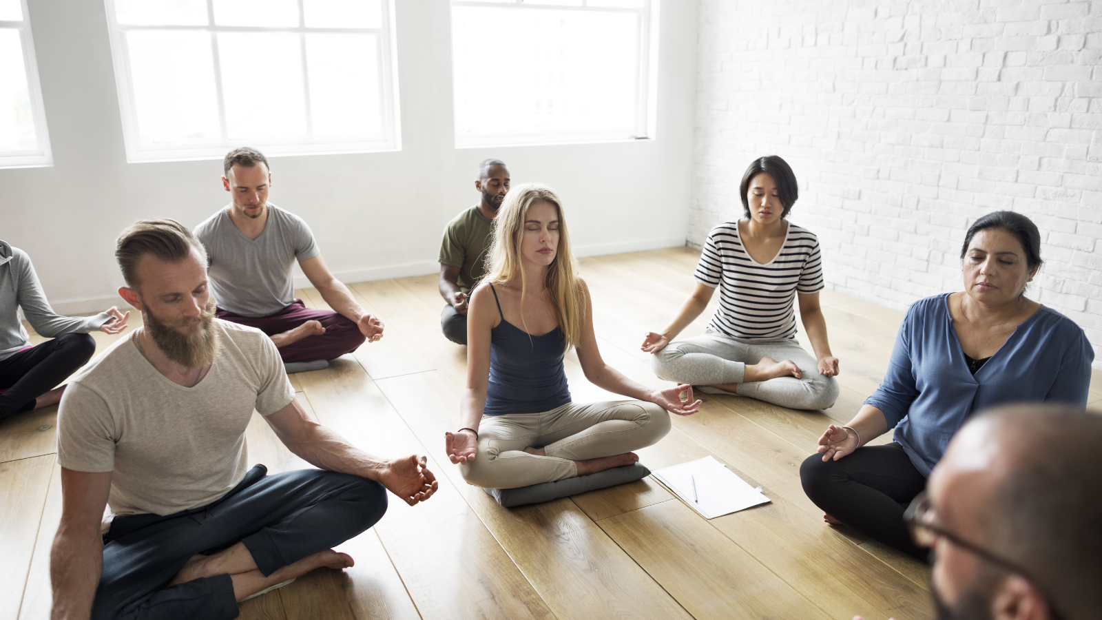 Diverse yoga class meditation, breath work, with yoga instructor. 