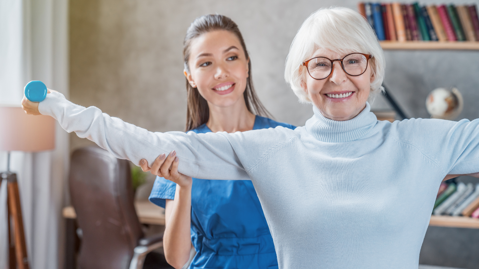 Senior woman training with physiotherapist at home.