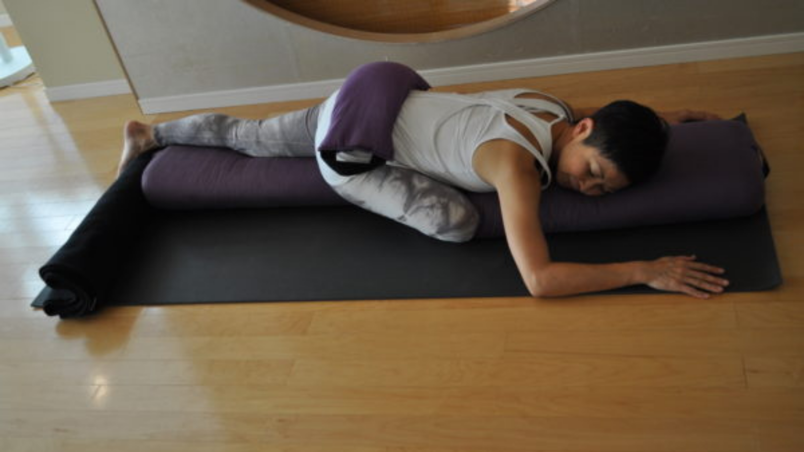 Using a sandbag as a prop while practicing Supported Pigeon Pose. 