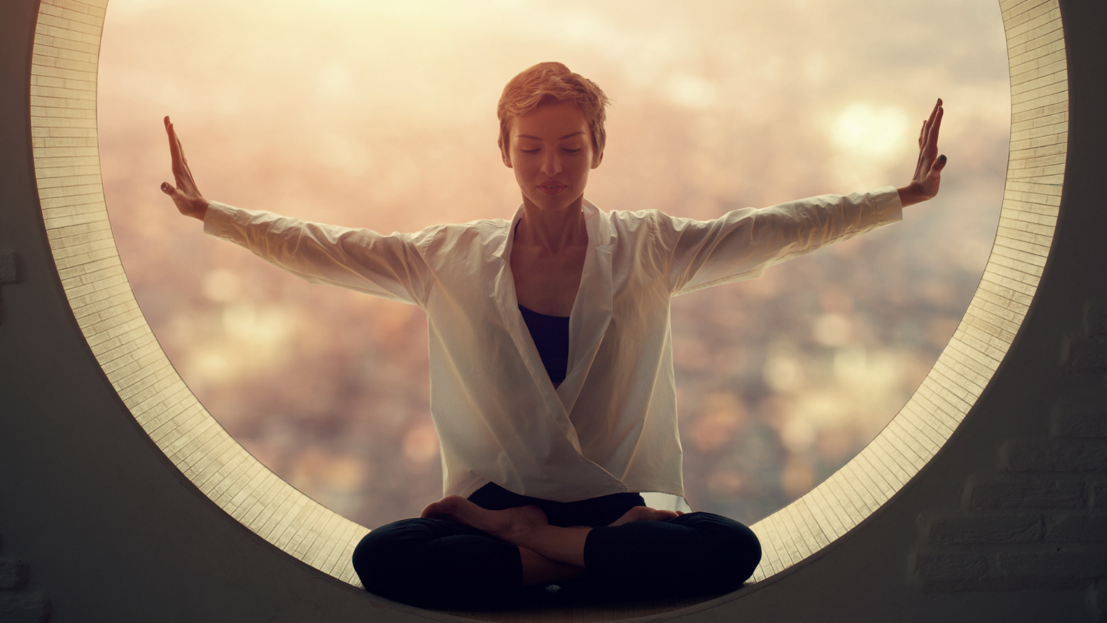 A young woman meditating in Padmasana (Lotus Pose), reflecting on the Yamas or ethical rules of yogic philosophy.