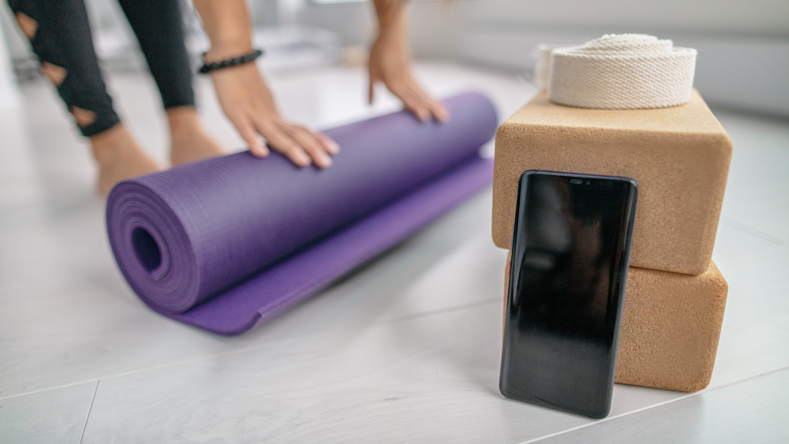 Phone app screen closeup at fitness yoga studio in indoor gym or at home.