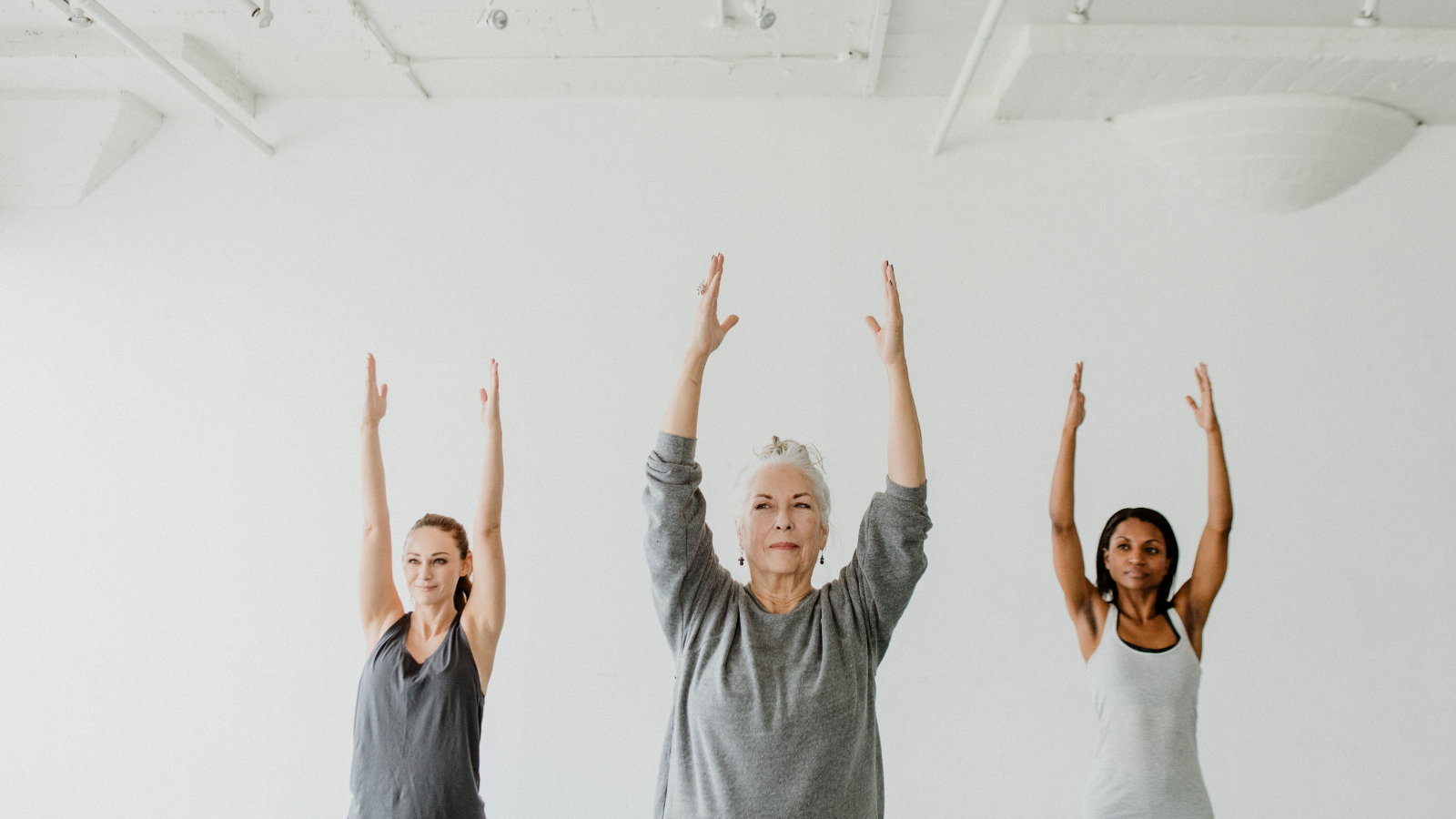 Diverse people practicing Urdhva Hastasana Pose.