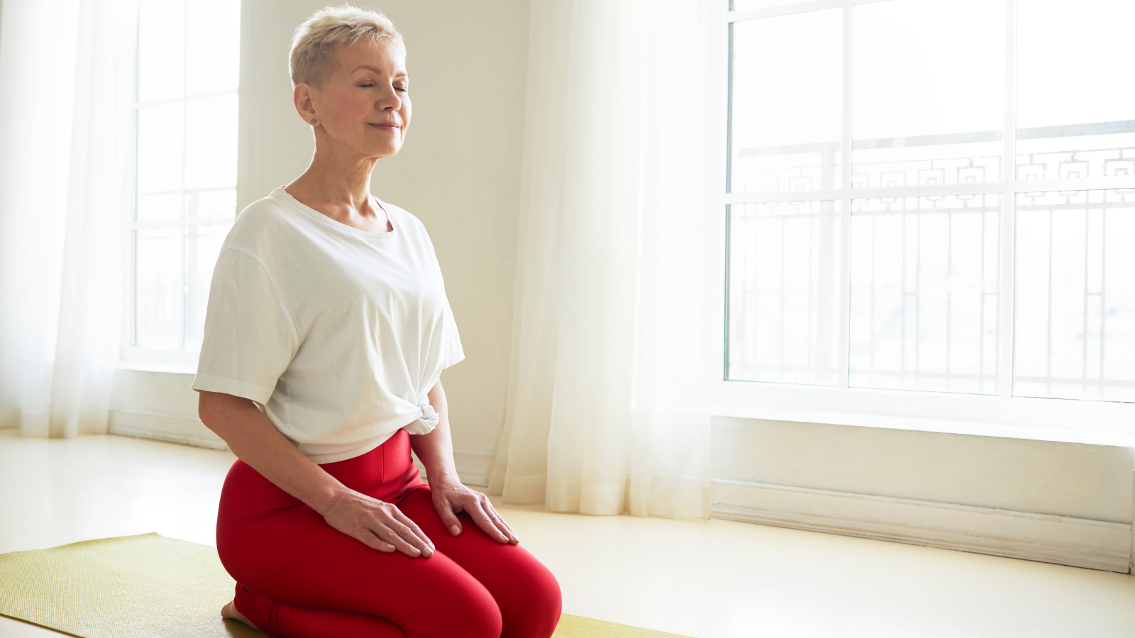 Spirituality, zen, and balance concept. Mature female sitting in Virasana pose practicing nose breathing