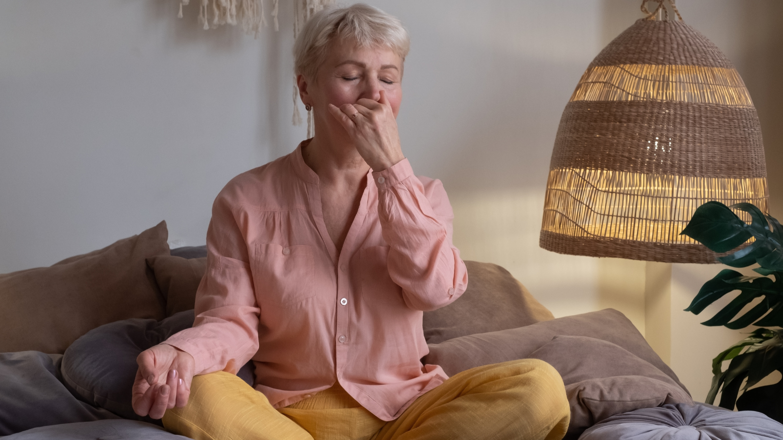 Senior yogi practicing Alternate Nostril Breathing exercise, Nadi Shodhana Pranayama