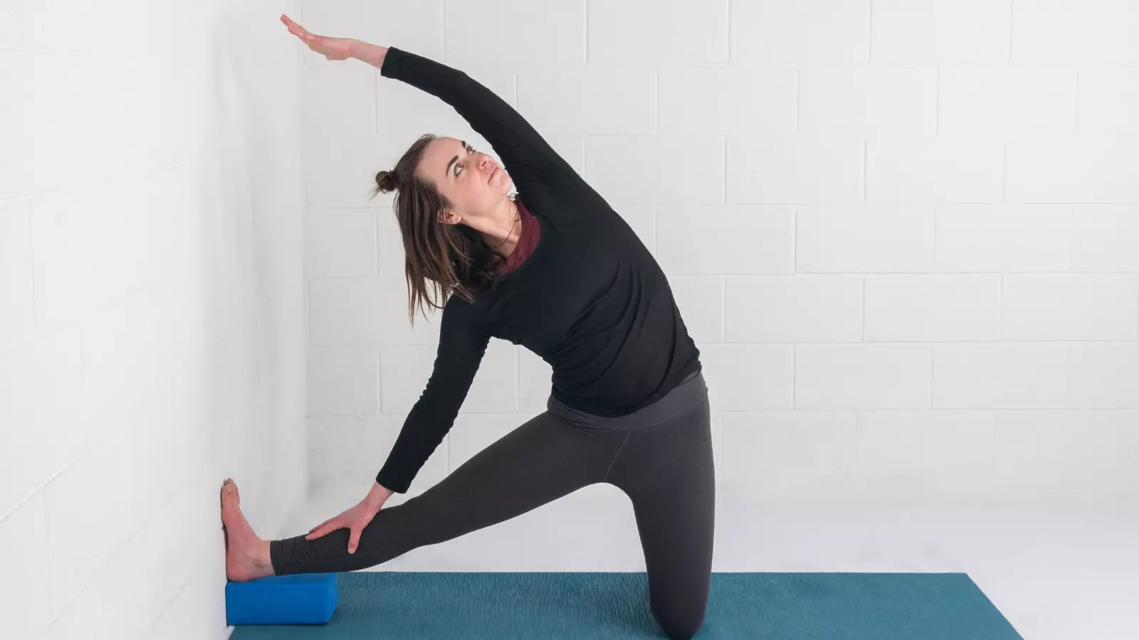 How to practice Gate Pose or Parighasana at the wall and with a block for extra support.