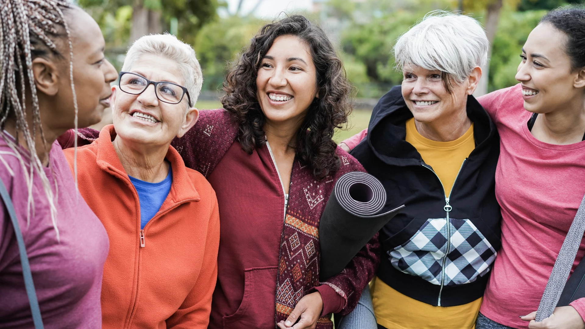 Happy multi generational women having fun together after yoga outdoors -Concept of slow paced yoga for healthy aging.