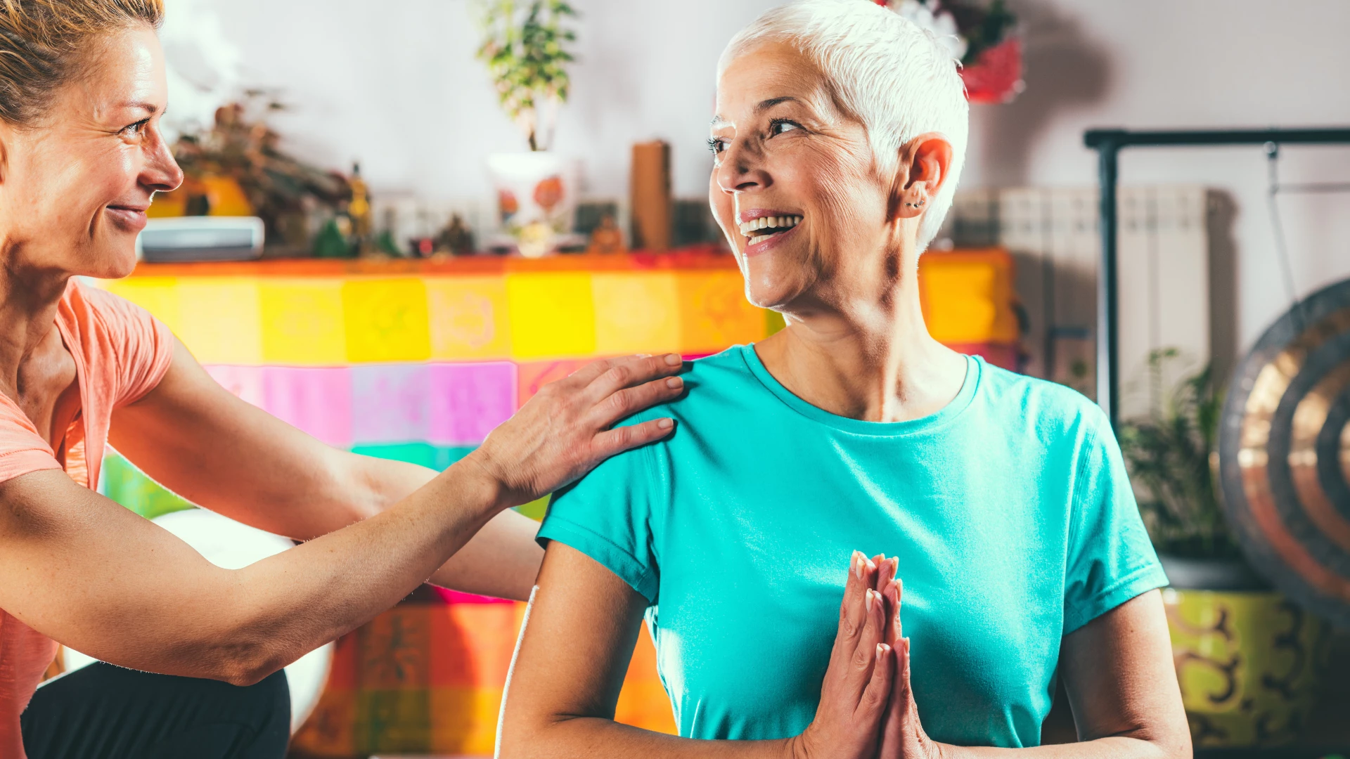 Yoga Somatic instructor with senior woman, doing yoga. Somatics & Interoception concept and healing concept.