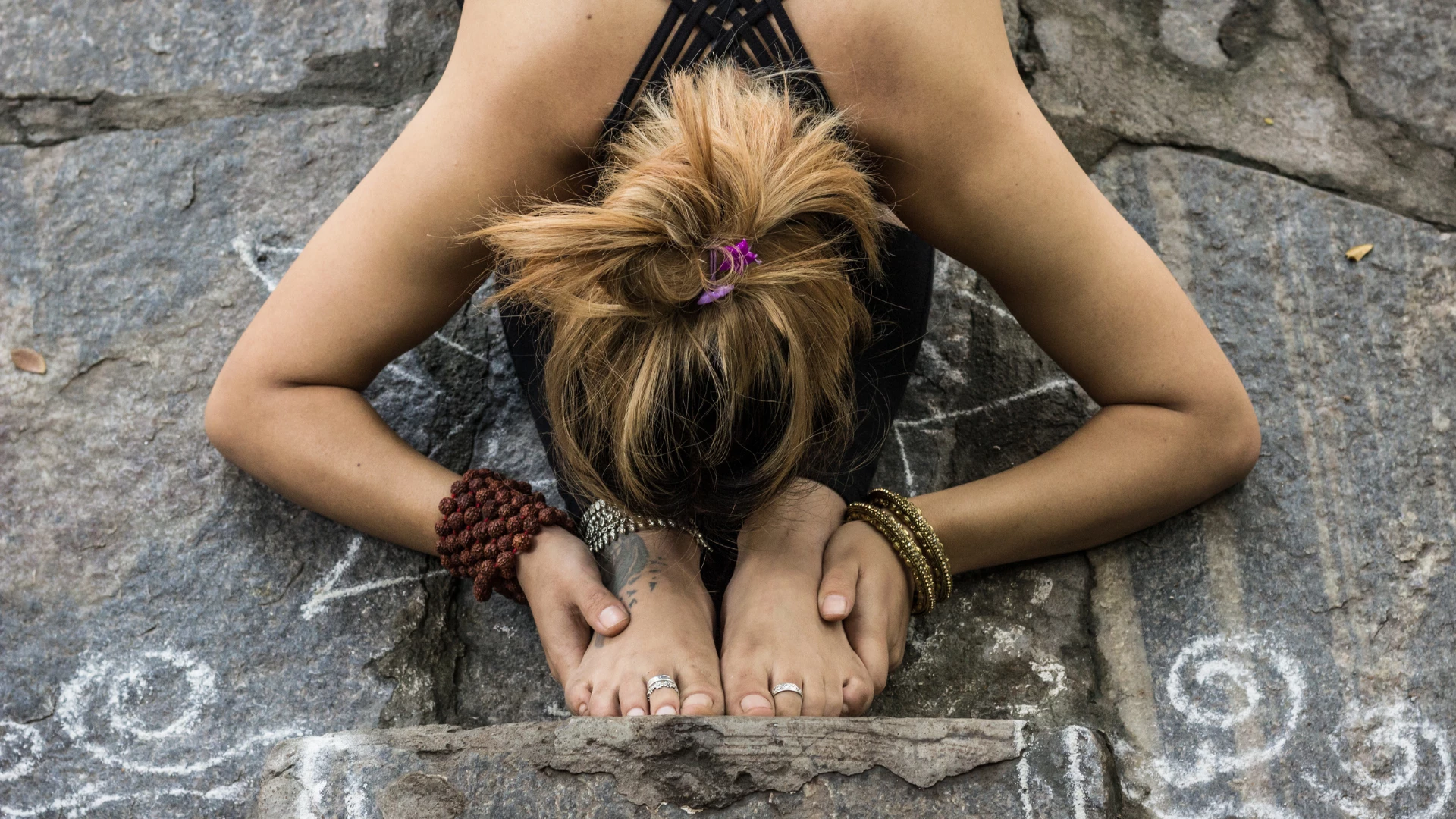 A woman meditating are consciously aware and taking the yogic value of responsibility in her actions.