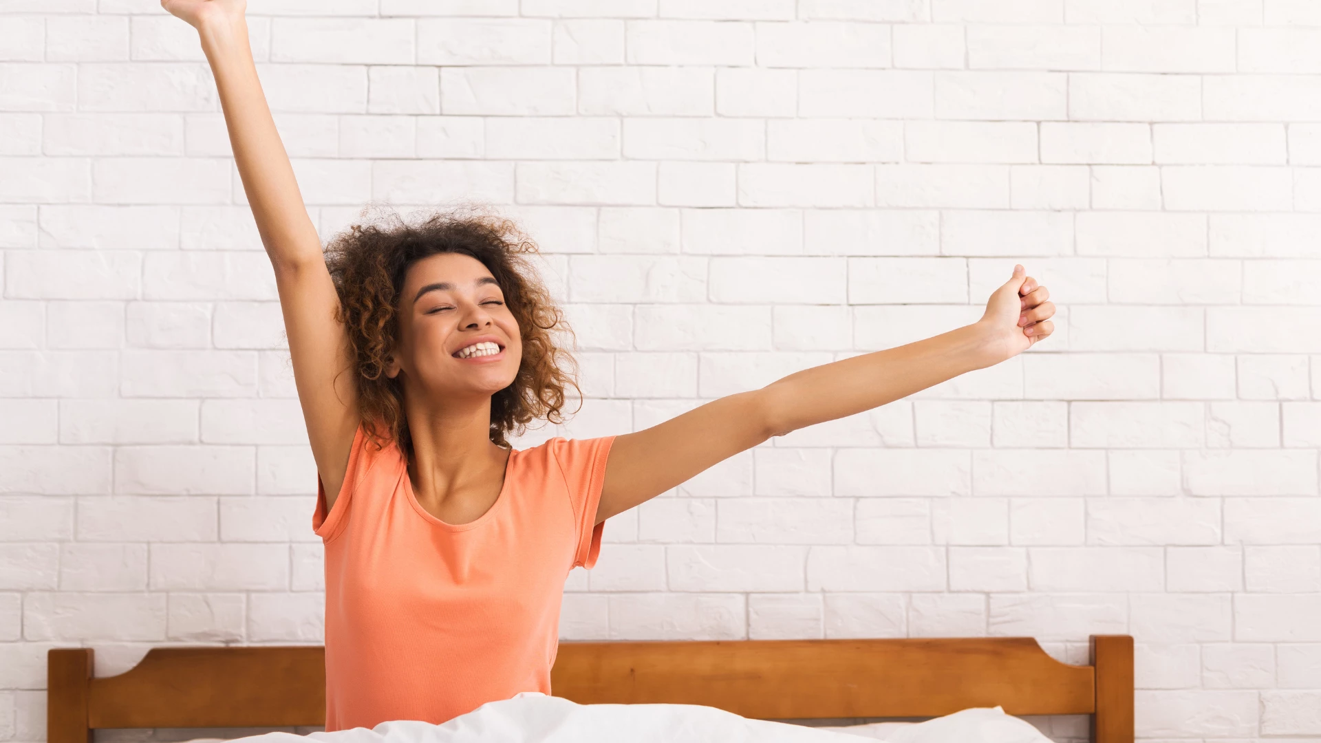 African-american woman stretching in the morning-- movement is similar to pandicuation in yoga