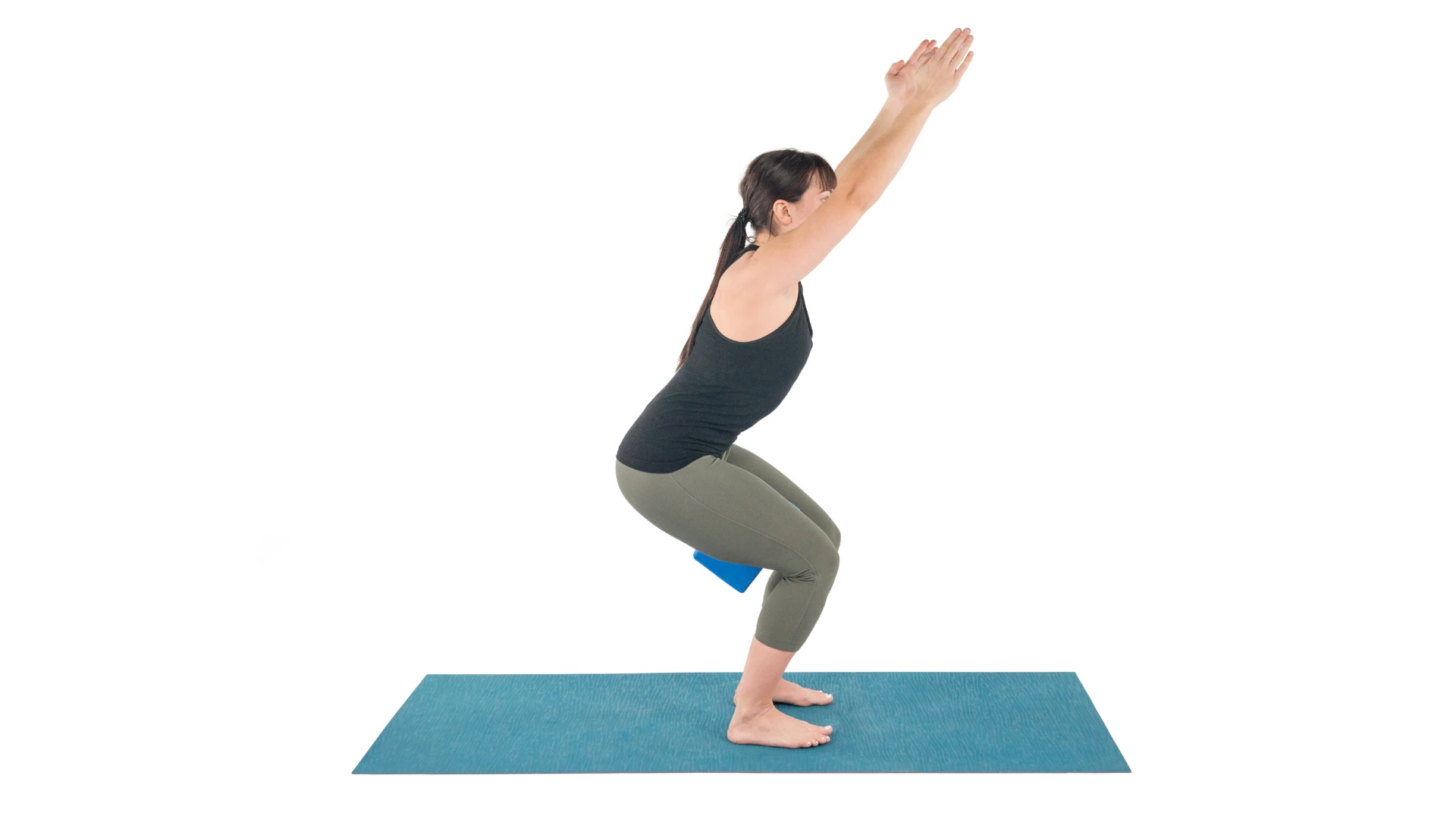 Utkatasana Pose practiced here with a yoga block to help engage the leg muscles.