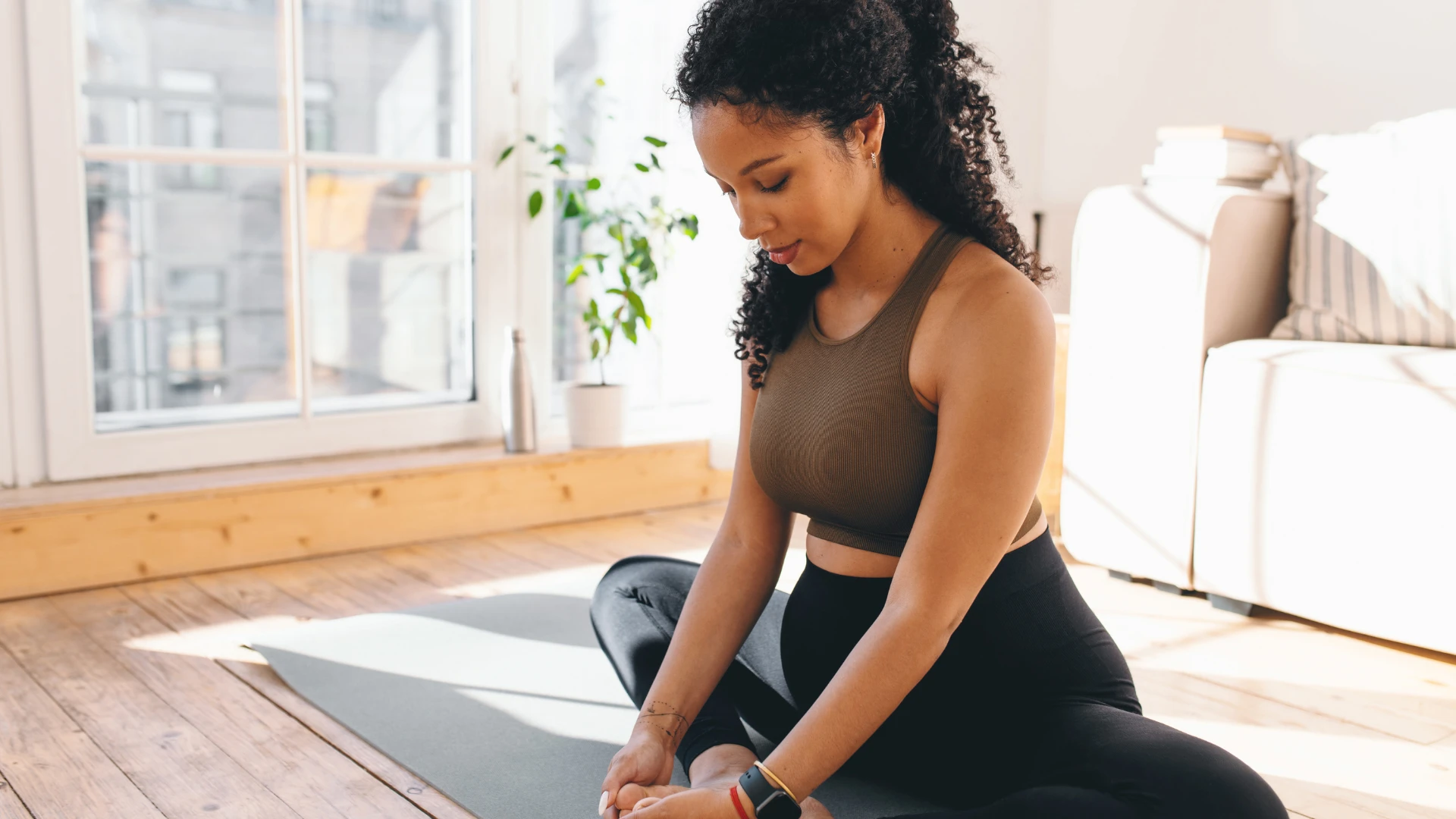Woman preparing for mindful yoga practice listening to body wisdom rather than forcing poses