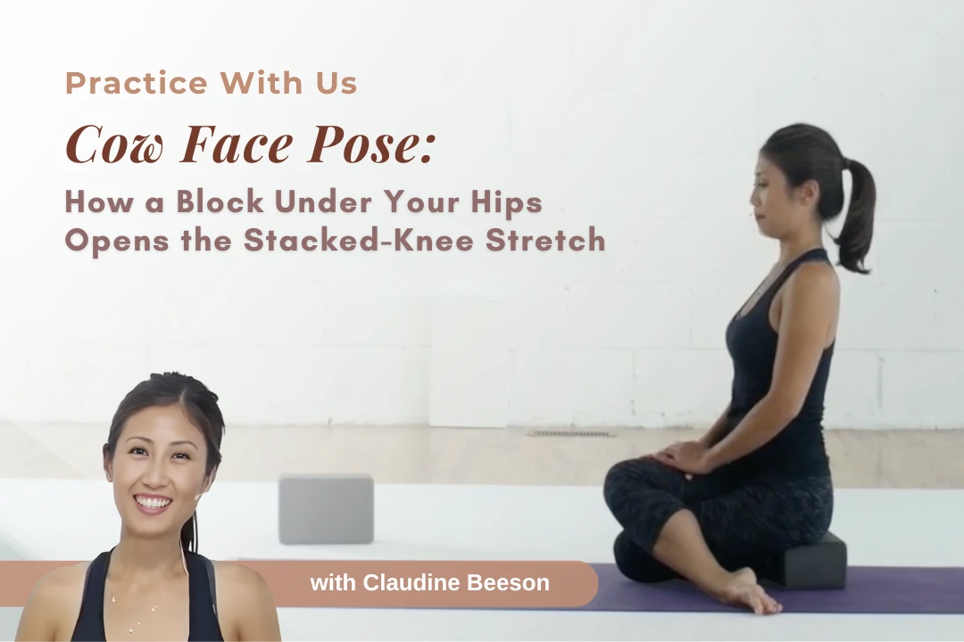 Claudine Beeson demonstrating Cow Face Pose (Gomukhasana) legs variation with knees stacked and a block supporting the hips.