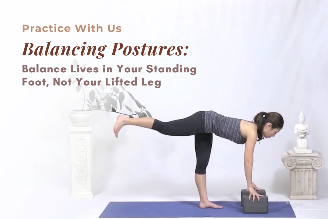 Claudine Beeson demonstrating a balancing posture, Tree Pose, with a block for support and a steady standing leg.